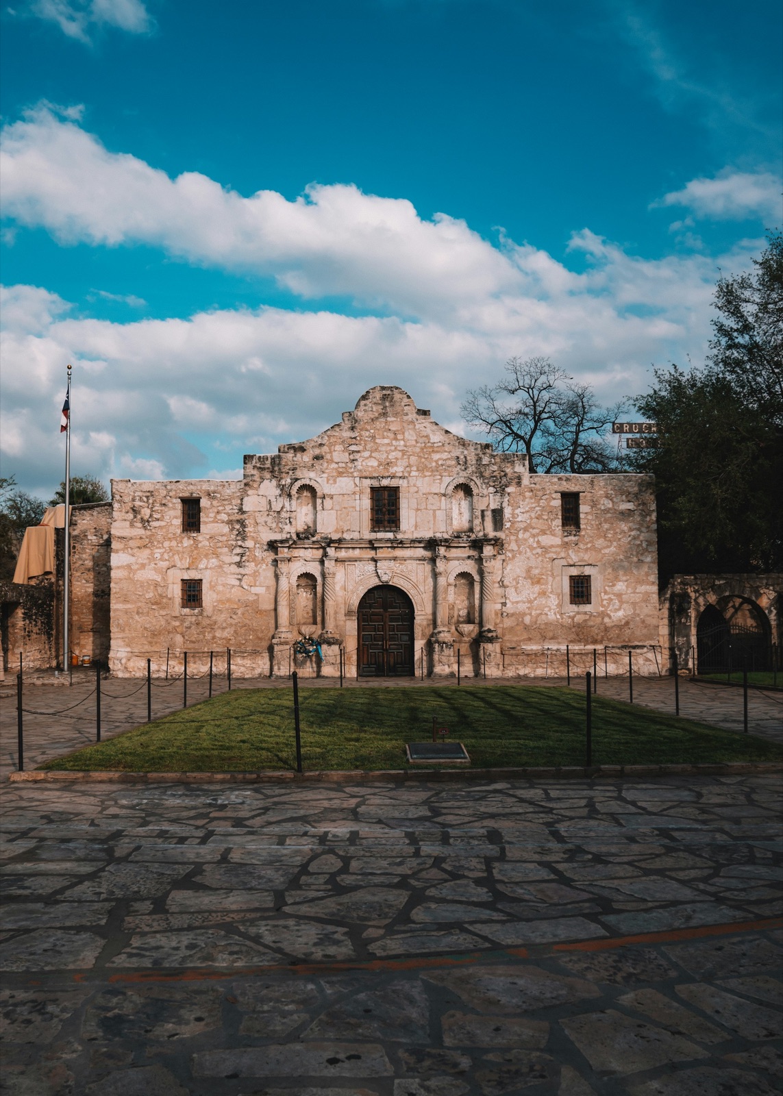 Stone facade of the Alamo under a bright sky