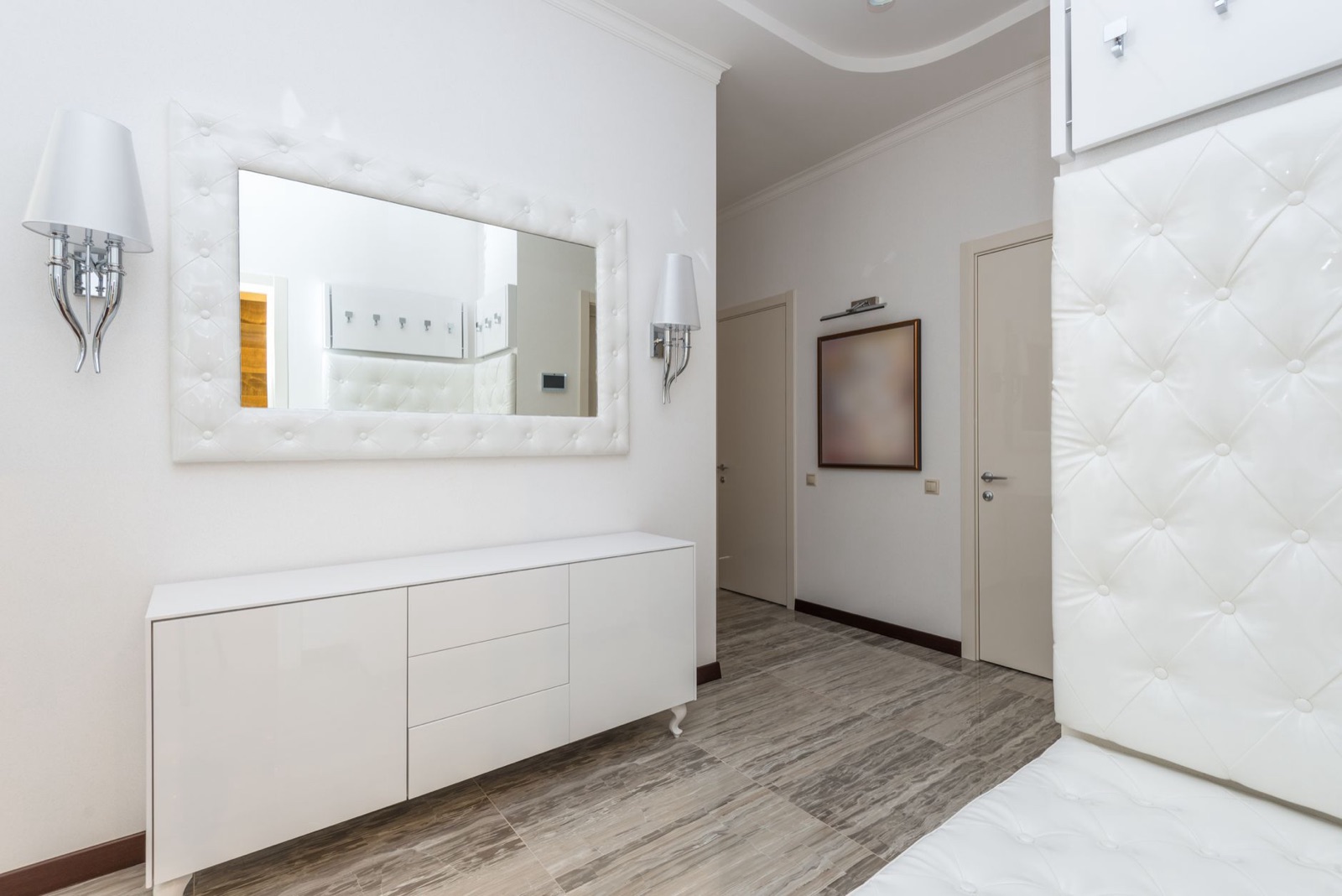 Bright apartment entry hall with mirror and console