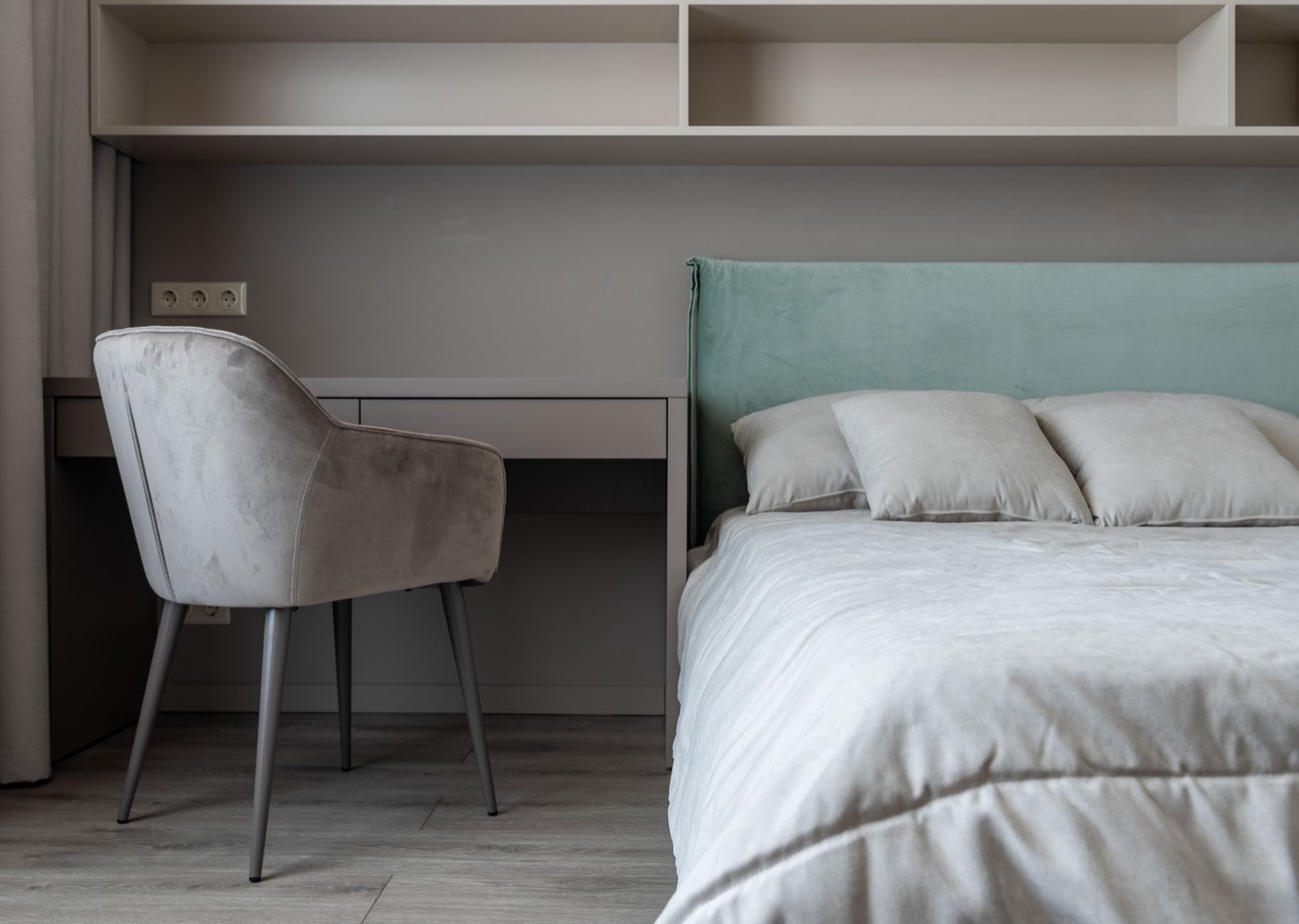 Bedroom corner with desk and upholstered chair