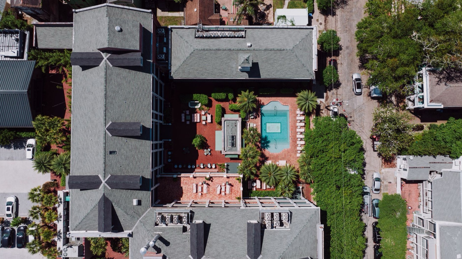 Aerial view of a courtyard pool between residential buildings