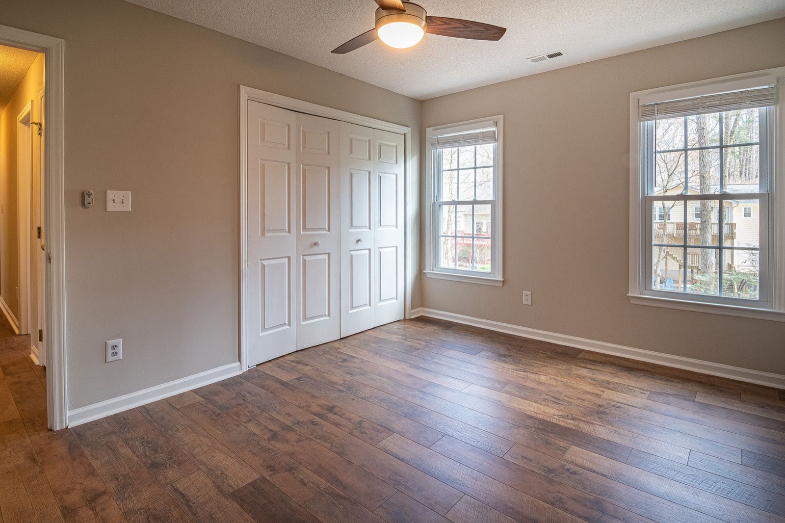 Empty room with wood floor and ceiling fan
