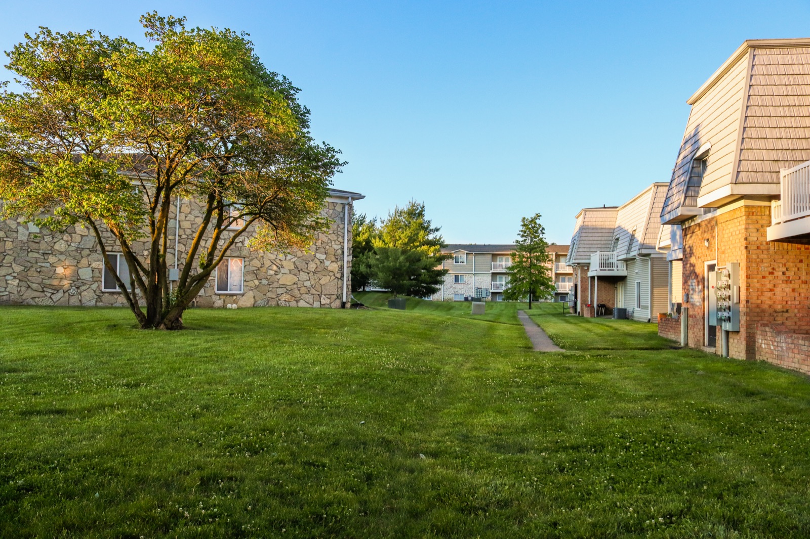 Garden-style apartment buildings around a shared lawn