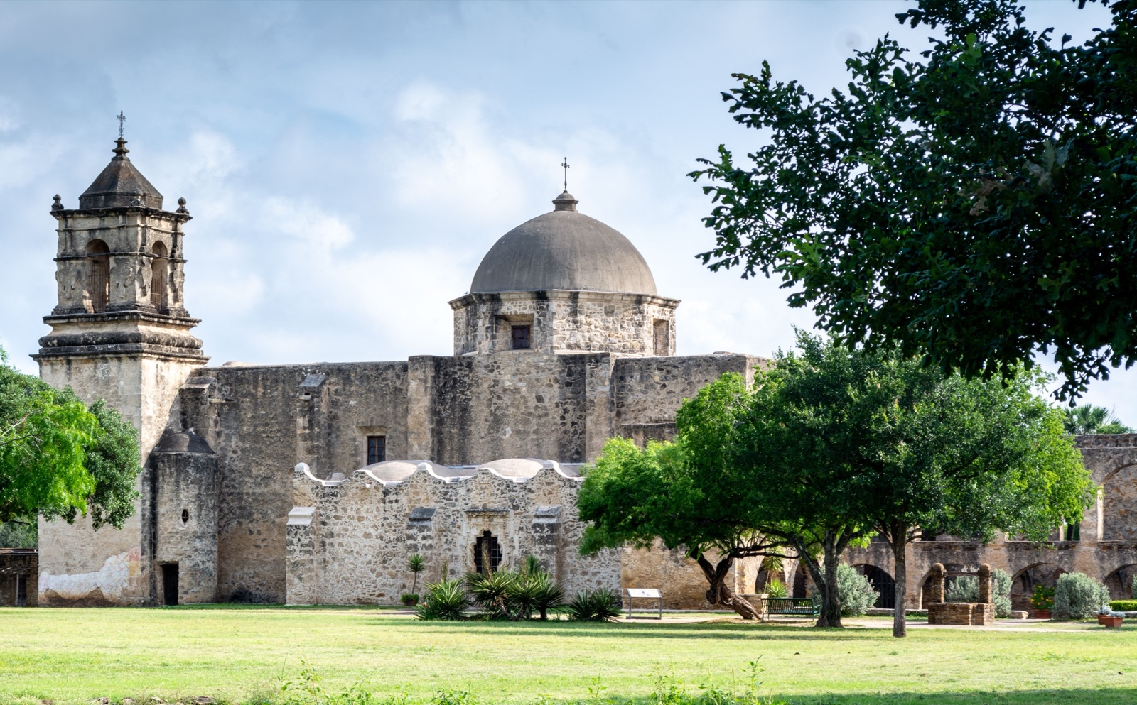Mission San Jose church and bell tower behind oak trees