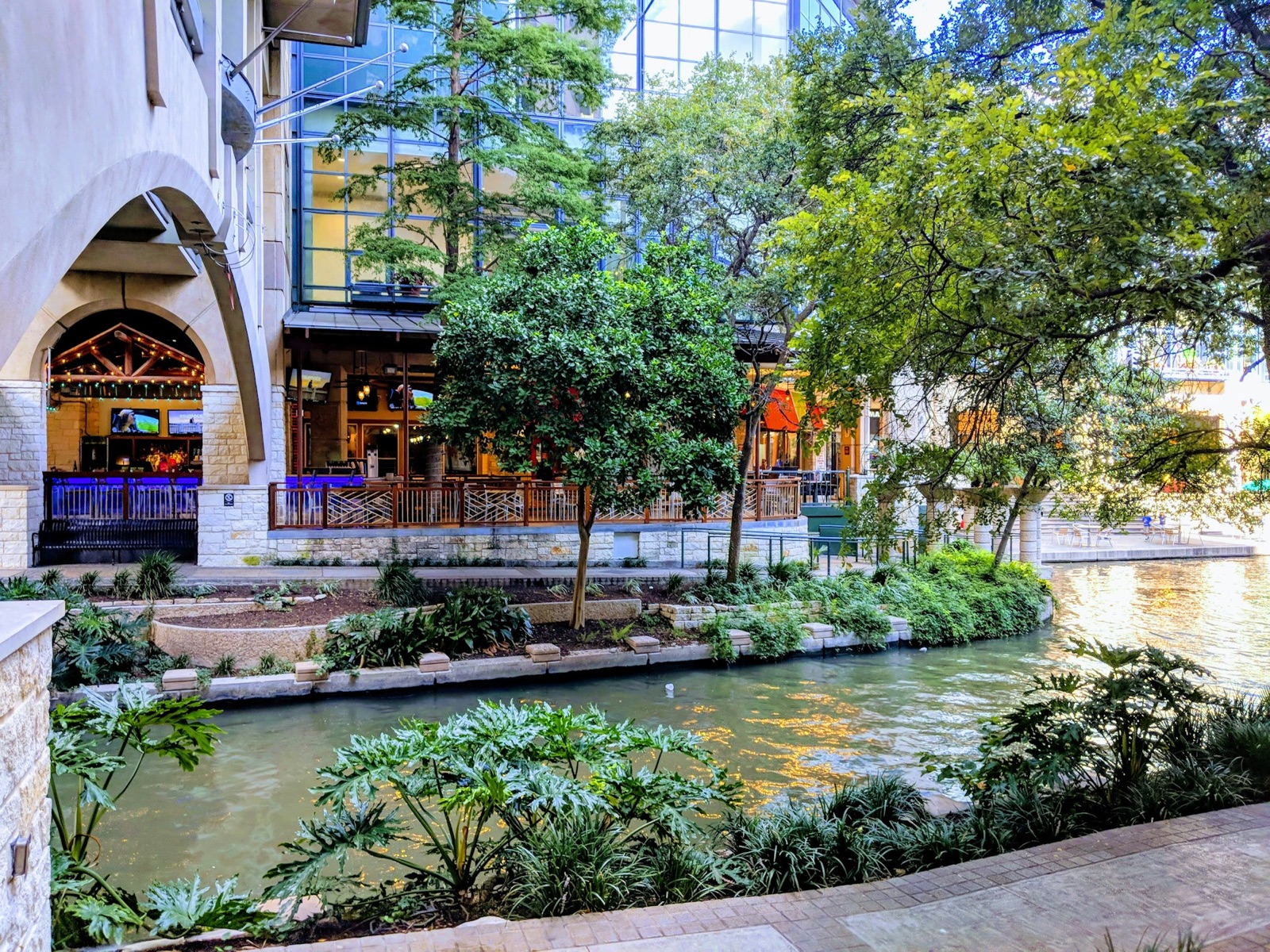 Shaded riverside terrace and greenery on the San Antonio River Walk