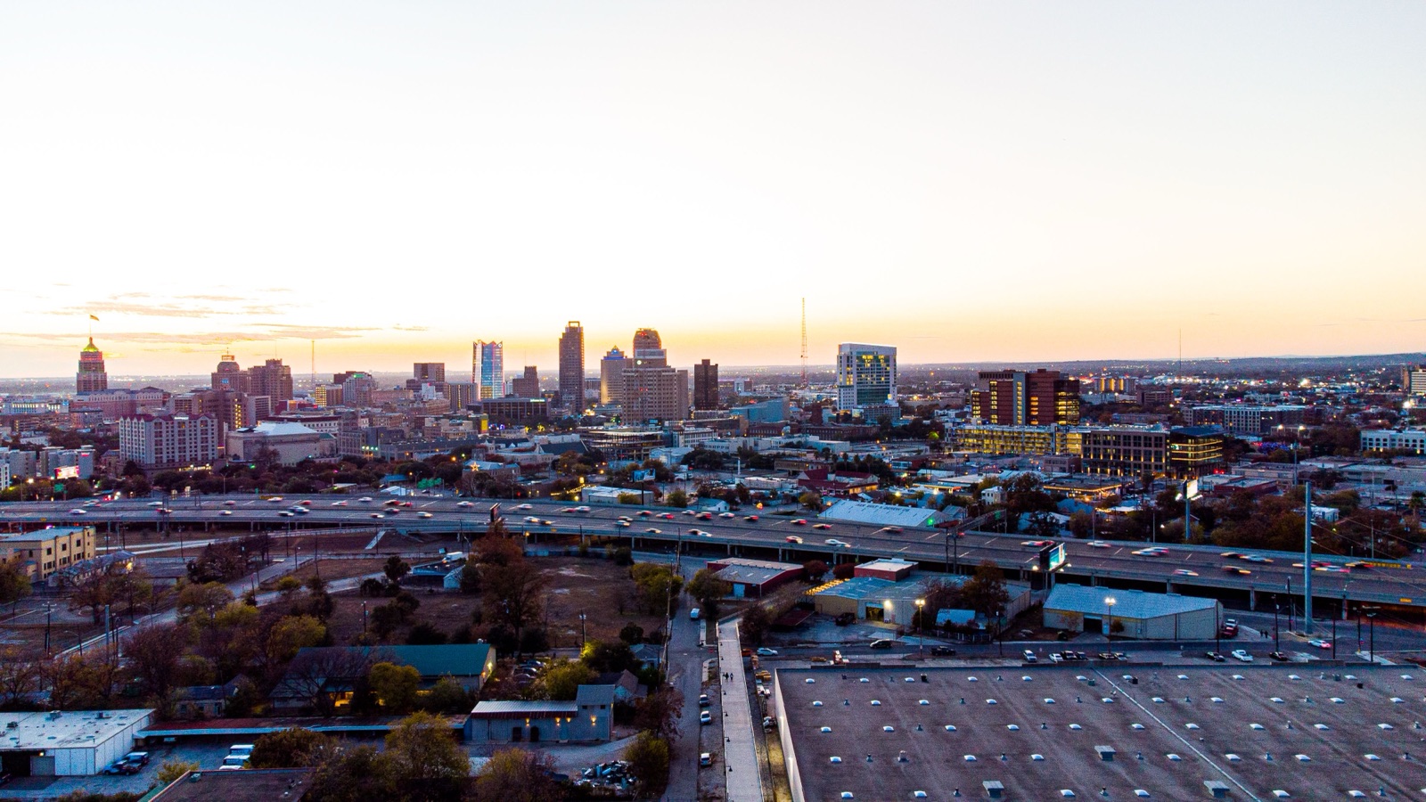Downtown San Antonio skyline at dusk with highway traffic below