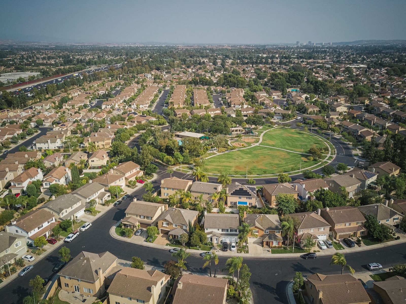 Aerial view of a suburban neighborhood around a central park
