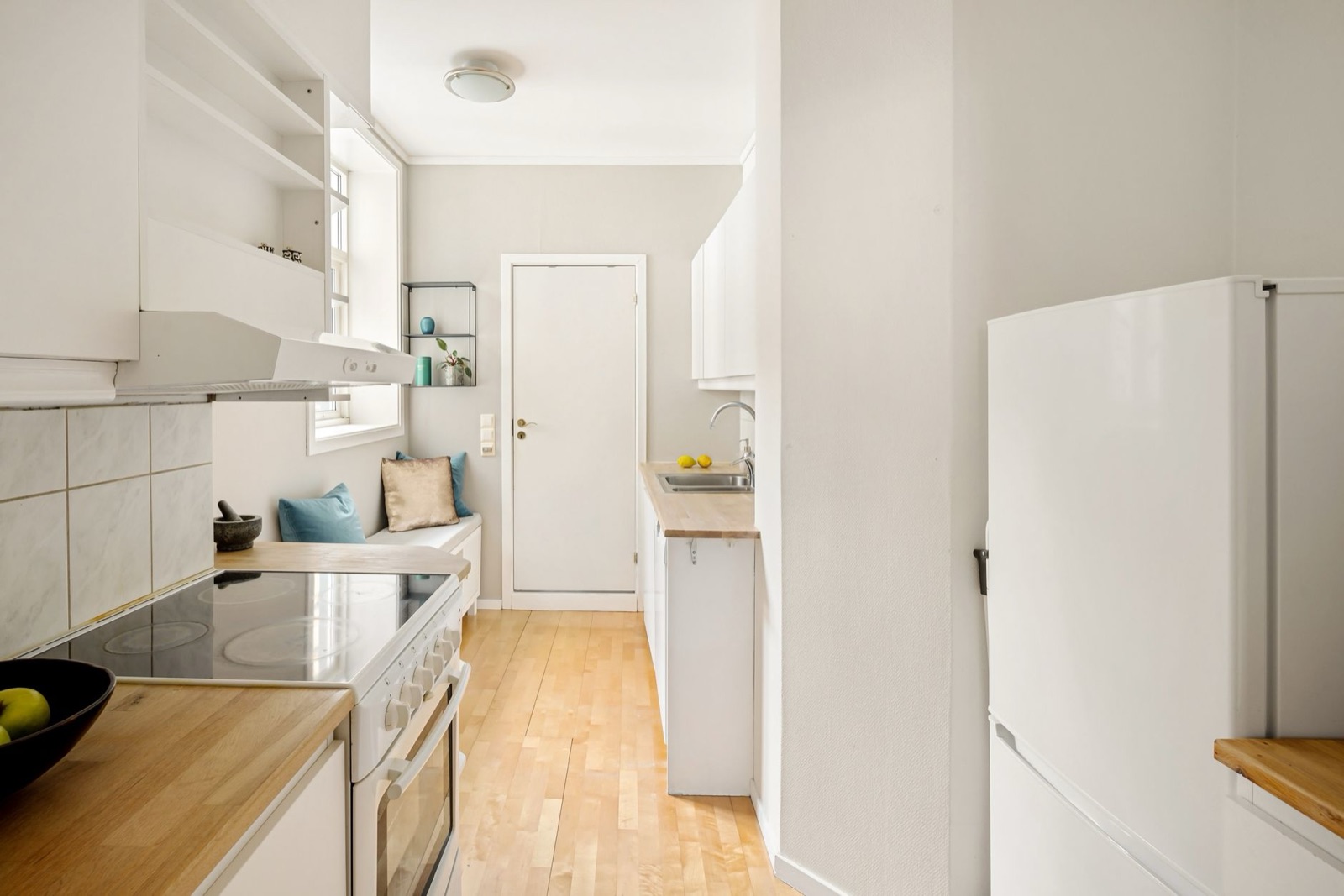 Compact white kitchen with wooden counters